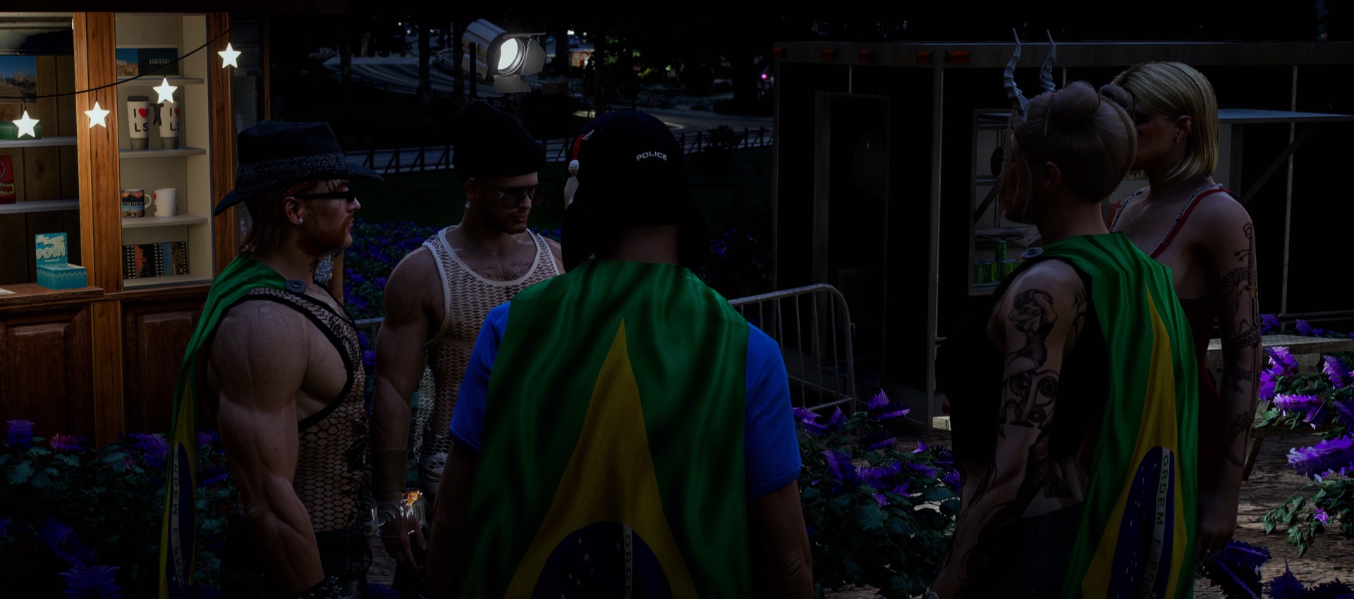 Friends talking by the merch stall and purple flowers