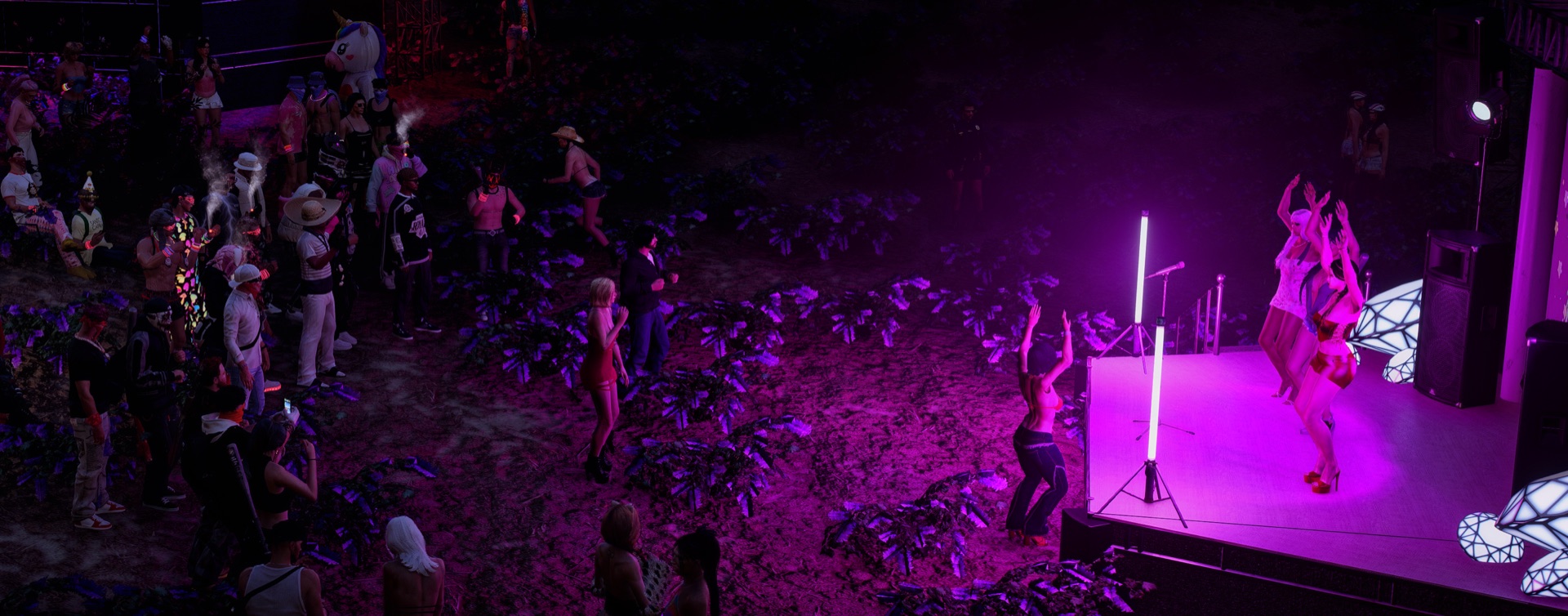 Three artists dancing on the purple-lit stage