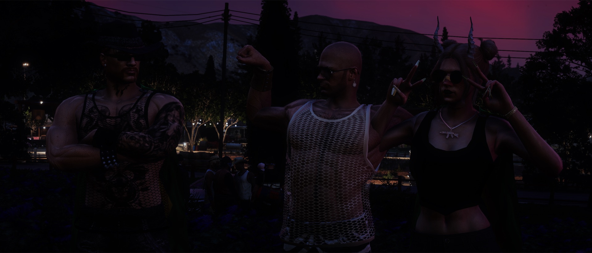 Three attendees posing together at dusk