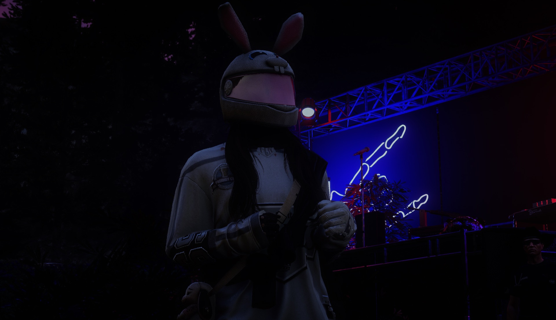 An attendee in a bunny helmet by the blue-hand stage