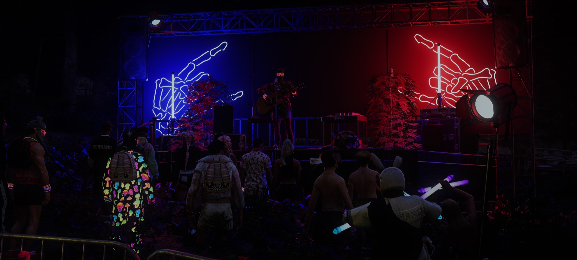 The crowd watching a guitarist on the neon-hand stages